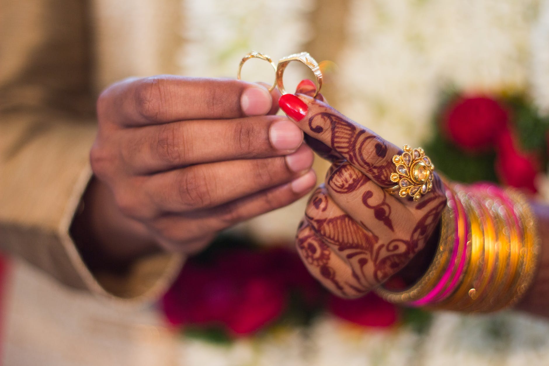 man and woman holding wedding rings