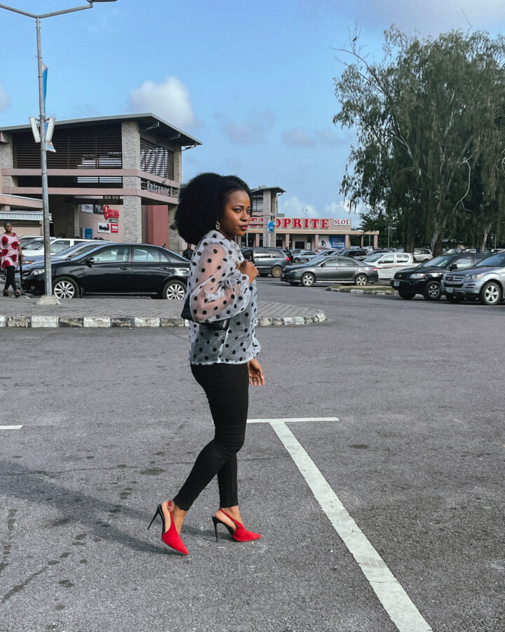 Iruoma Osonwa at the Indomie cafe in a white polka dot shirt and black pants