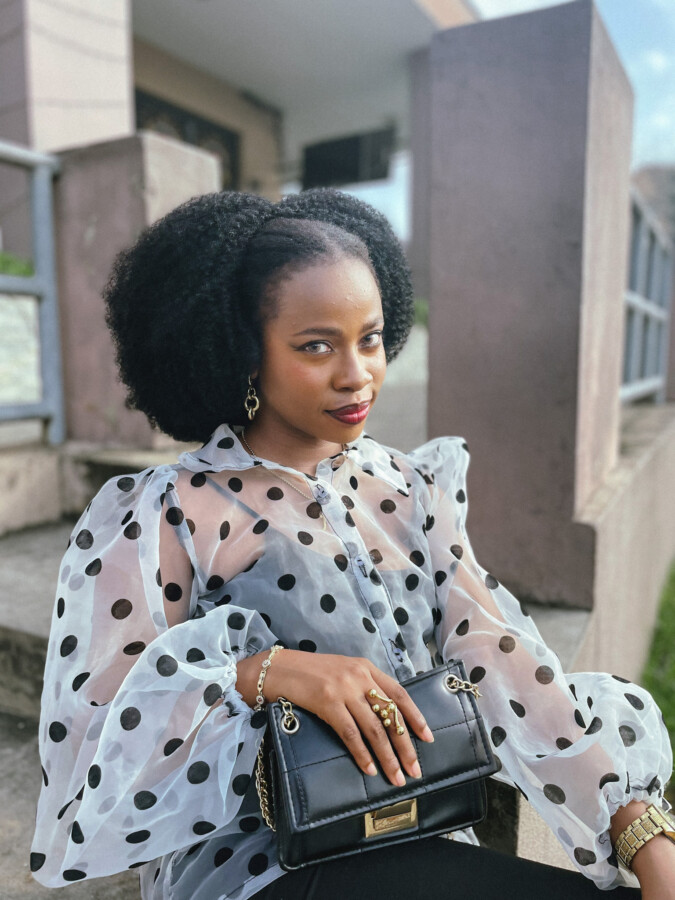 Iruoma Osonwa in a polka dot chiffon top for her monthly favorites.
