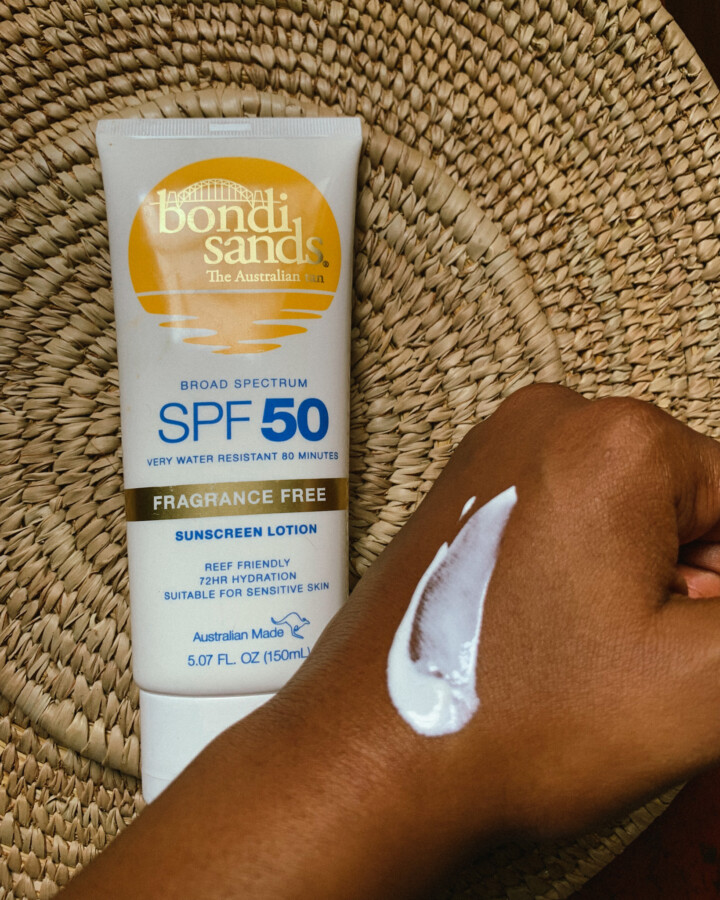 Texture of the bondi sands chemical sunscreen on Iruoma's hand