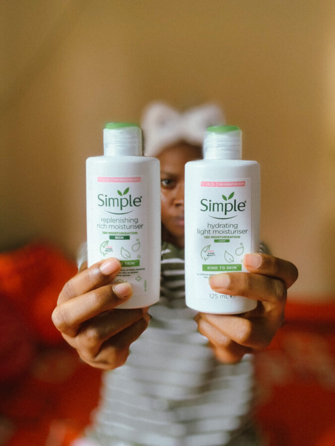 Blogger-Iruoma-Osonwa-holding-the-Simple-hydrating-moisturiser-and-Simple-replenishing-rich-moisturiser