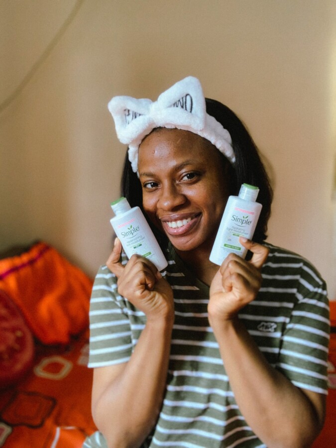 Nigerian beauty blogger Iruoma holding the 2 simple moisturizers