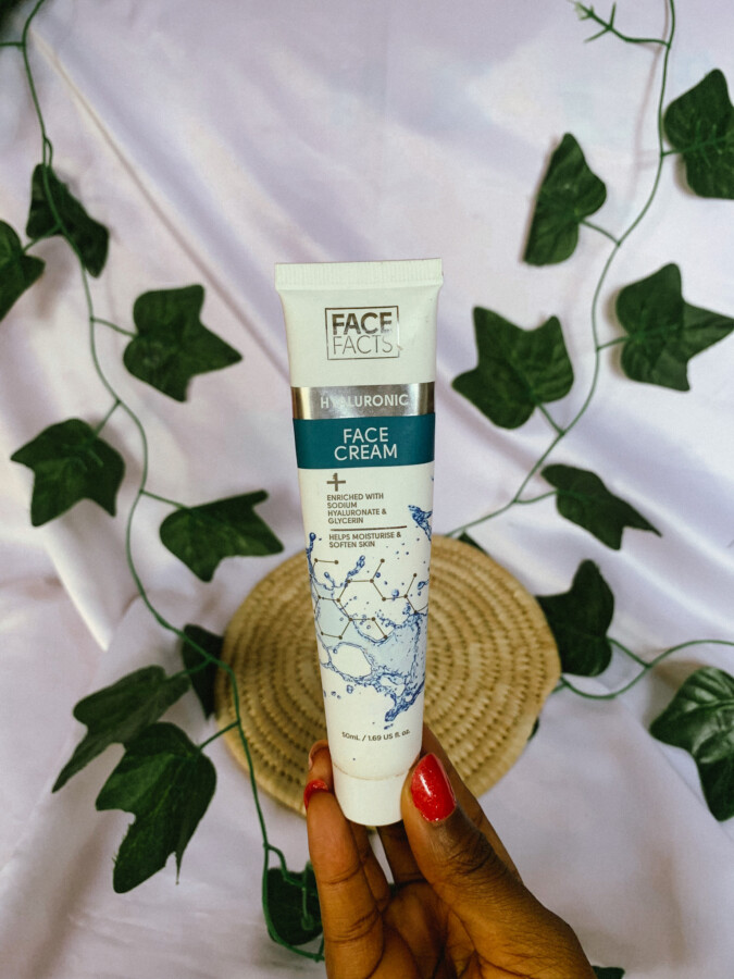 Blogger Iruoma holding the face facts hyaluronic face cream